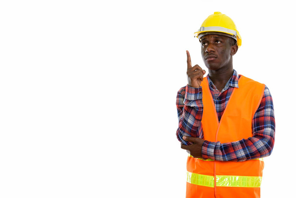 Studio shot of young black African man construction worker think - Фото, зображення