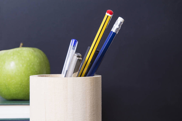 concept of back to school with apple, books, pens and blackboard - Photo, Image
