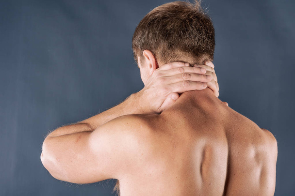 Man holding his neck trying to relieve pain - Photo, image