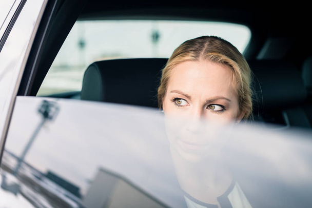 Beautiful businesswoman travelling in car - Photo, Image