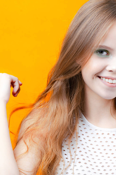 Young cute girl smiling on yellow background. Emotions and beauty - Fotó, kép