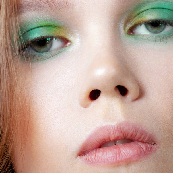 Young cute girl with colorful make-up close-up. Beauty and cosmetics - Photo, Image