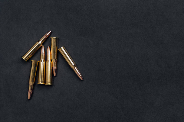 Rifle cartridges on a black background - Fotografie, Obrázek