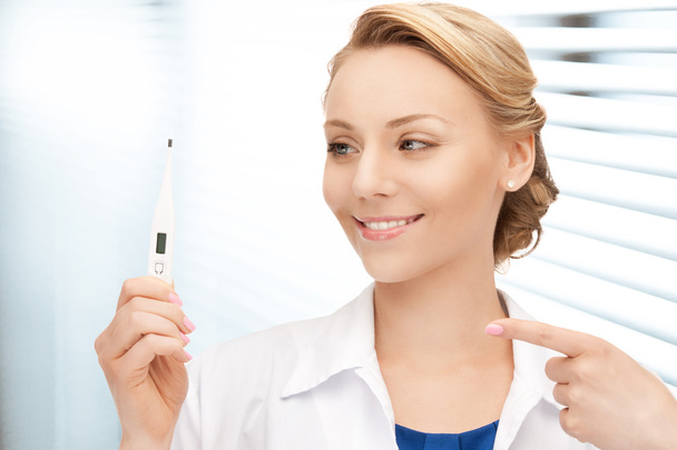 Attractive female doctor with thermometer - Foto, afbeelding