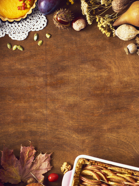 Thanksgiving background with autumnal fruits and gourds on a rustic wooden table - Photo, image
