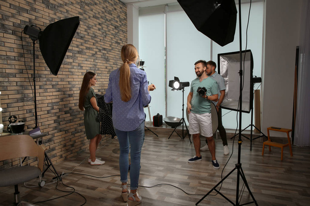 Professional team working with model in photo studio - Foto, imagen