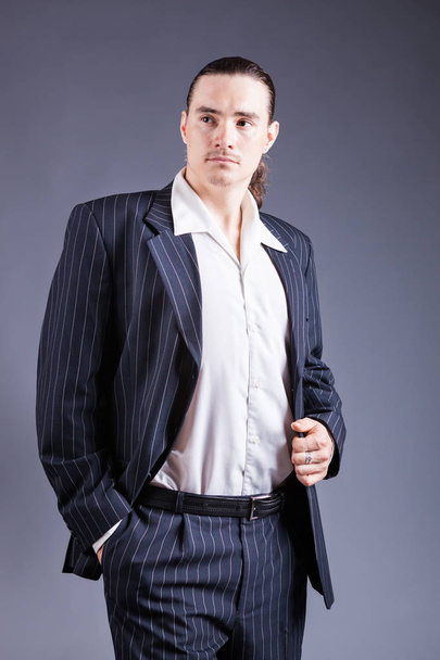 Young male confident male posing in gangster style suite - Фото, зображення