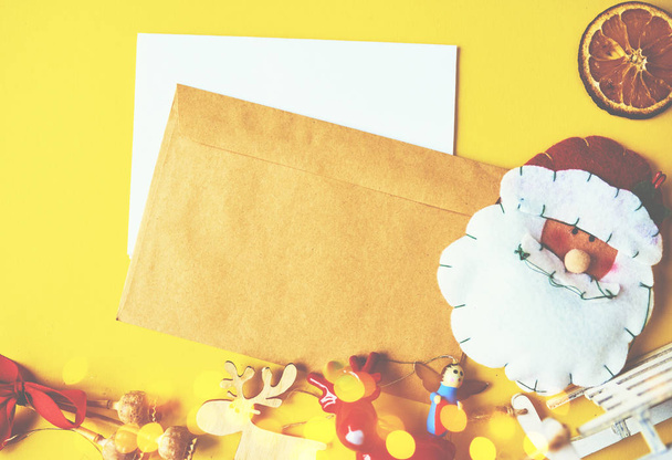 A lot of Christmas decorations and toys  with Christmas letter on yellow background. Space for text. - Foto, afbeelding