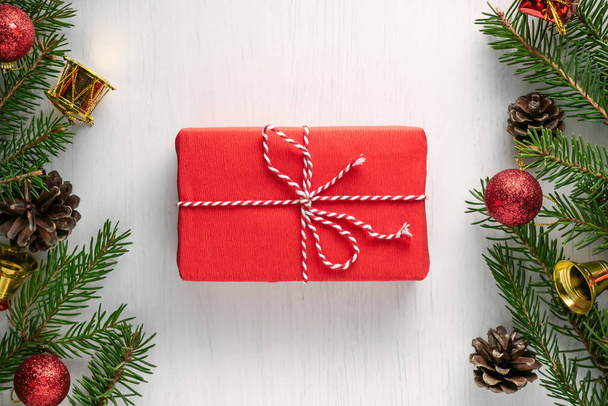 Christmas gift wrapped in red paper and twine - Фото, изображение