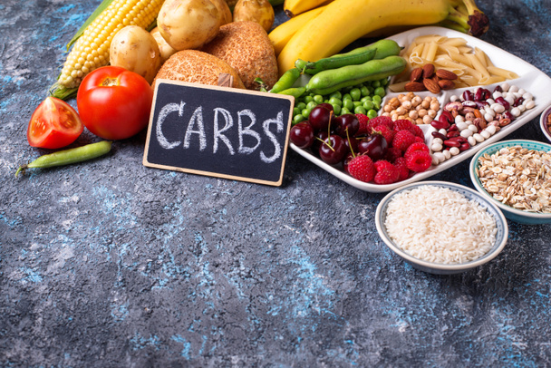 Food sources of carbohydrates. Cereals, beans, fruits, vegetables, berries, nuts and bread. - Photo, Image