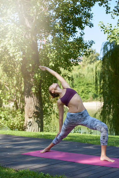 Full length shot of sporty young woman doing yoga practice outdoor.  - Photo, Image