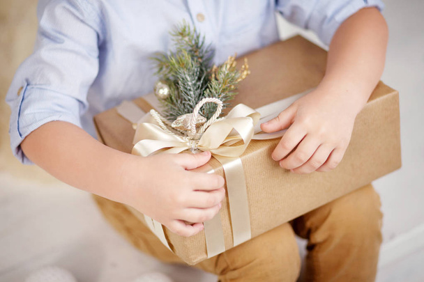 Child's hands holding gift box. Copy space. Christmas, hew year, birthday concept. - Fotografie, Obrázek