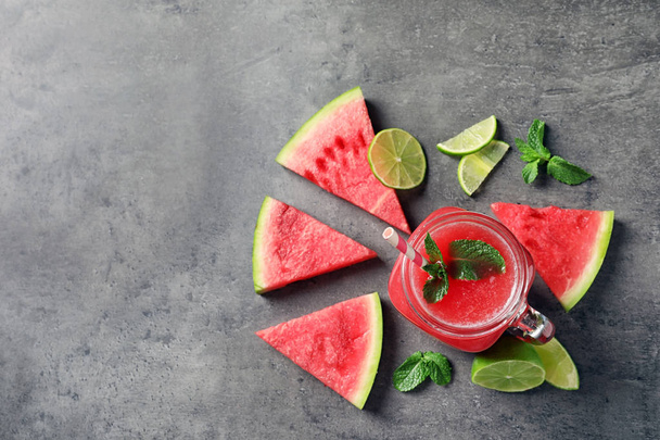 Summer watermelon drink in mason jar, sliced fruits and space for text on table, top view - Photo, image