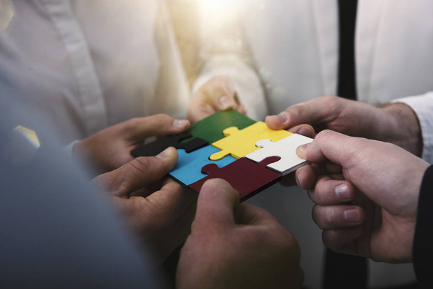 Teamwork of partners. Concept of integration and startup with puzzle pieces - Photo, Image