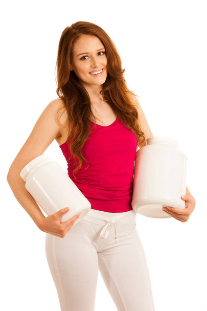 Attractive beautiful sporty woman holds blank plastic protein container - Фото, зображення