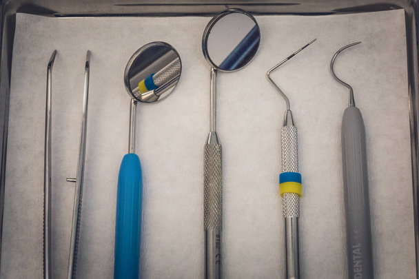 Detailed close up of different dental instruments and tools on a table, dentistry - Photo, Image