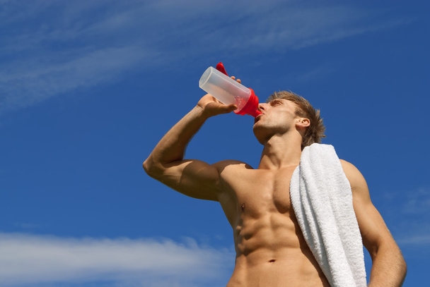 Young athlete drinking water - Photo, Image