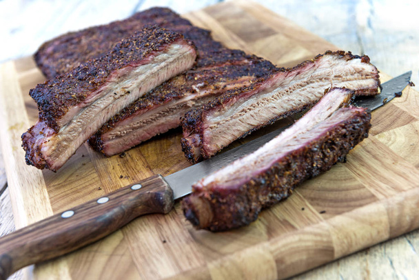 Cutting pork ribs and knife on cutting board - Photo, Image