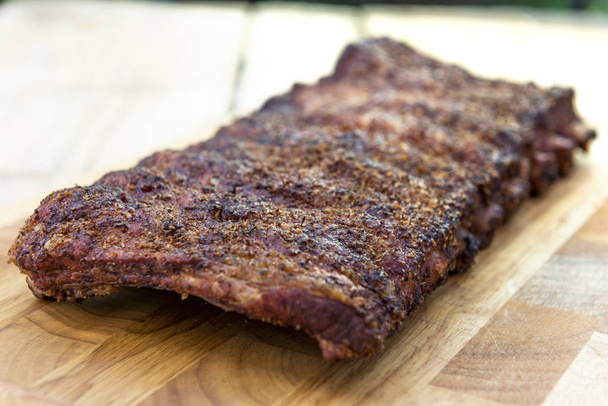 St Louis style grilled rack of pork ribs on cutting board - Photo, Image