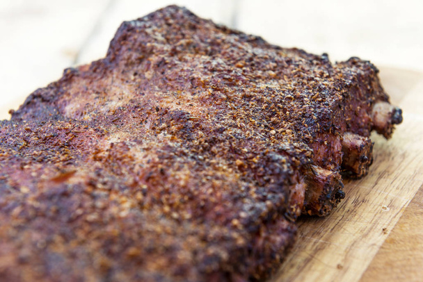 St Louis style grilled rack of pork ribs on cutting board - Photo, Image