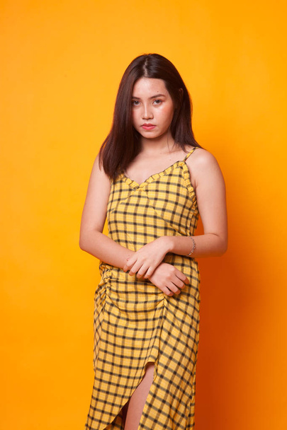 Portrait of beautiful young Asian woman on yellow background - Zdjęcie, obraz