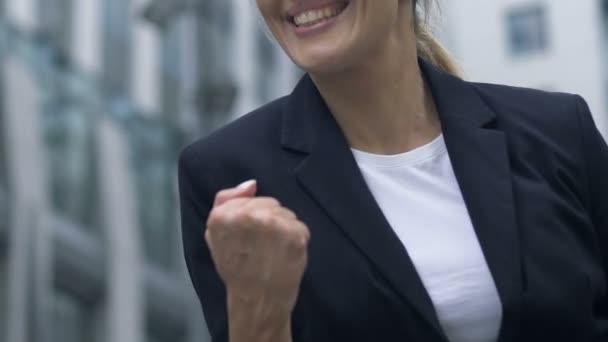 Cheerful woman showing yes gesture, happy to obtain desired position at work - Felvétel, videó