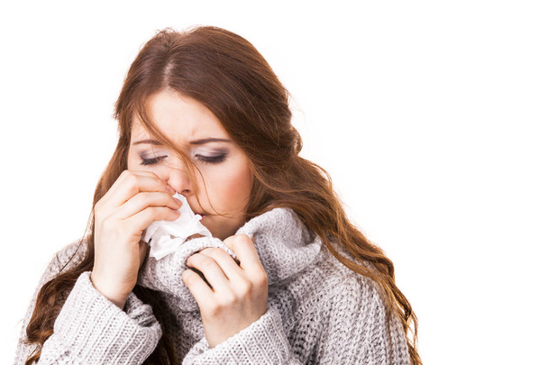 Sick freezing woman sneezing in tissue. Girl wearing warm sweater being cold and trembling. Flu or other virus. Health care. - Foto, afbeelding