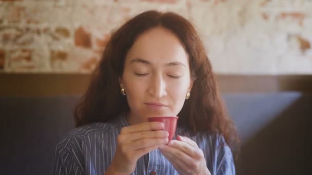 Portrait of Woman is drinking tea from red cup - Кадри, відео