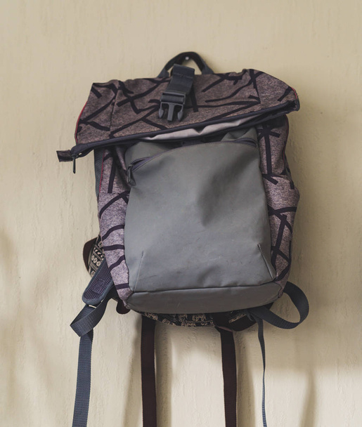 Purple School Backpack Hanging on the Wall - Isolated Object with White Background, Vintage Film Edit - Photo, Image