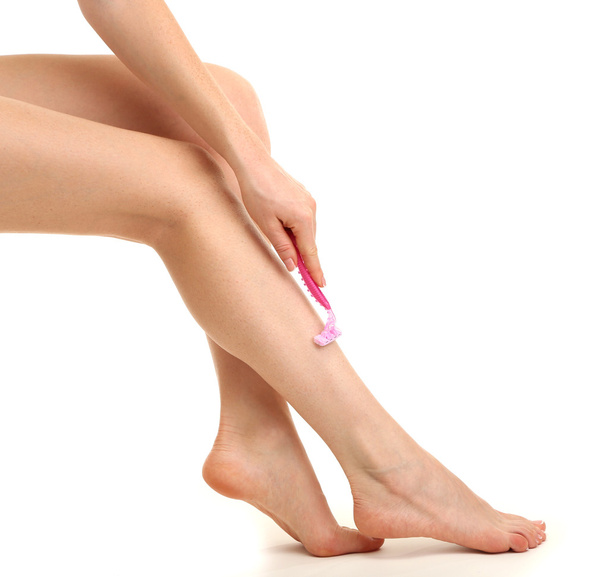 Beautiful woman is shaving her leg, isolated on white - Foto, Imagem
