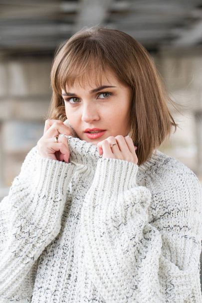 Portrait of a young girl in a men's sweater - Foto, afbeelding