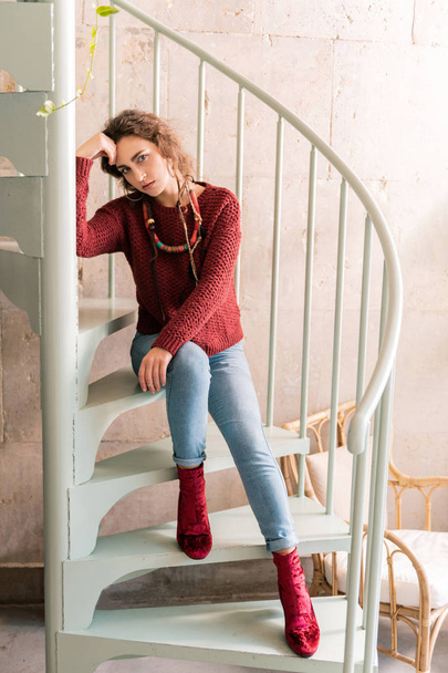 Stylish woman wearing dark red sweater and fashionable boots - 写真・画像