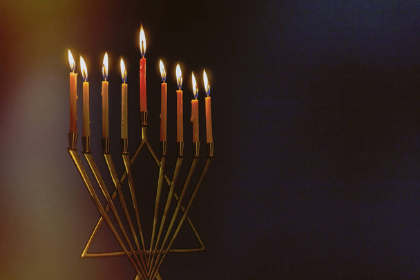 Menorah with colorful burning candles for Hanukkah on light blue background, close up - Photo, Image