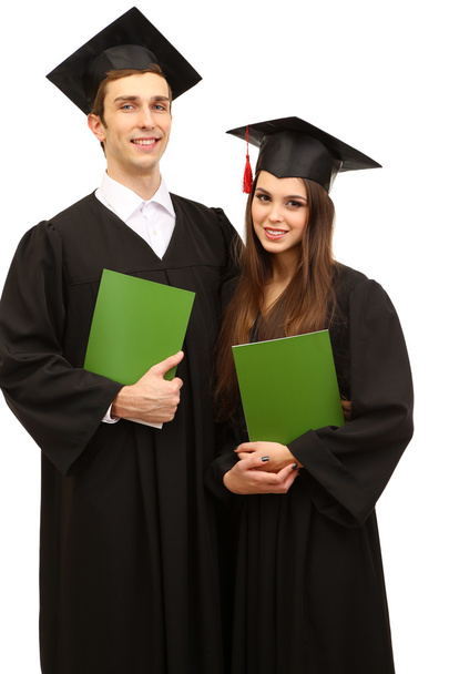 Two happy graduating students holding graduation certificate isolated on white - Valokuva, kuva