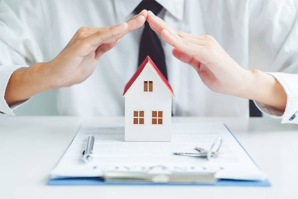 The concept of home ownership Sale agent Insurance Home protection concept - 写真・画像