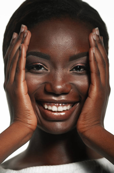 lifestyle and people concept:  Portrait of a beautiful young African woman smiling. - Fotó, kép