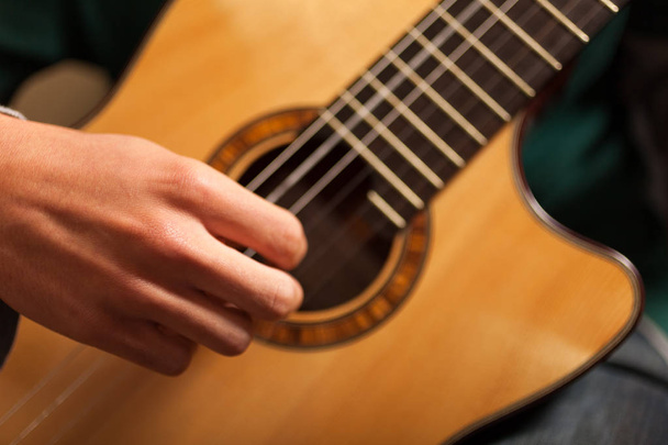 Detail of a classical guitar player with guitar  - Zdjęcie, obraz