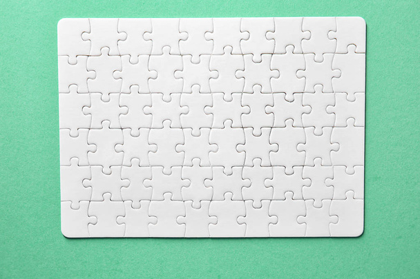 Assembled jigsaw puzzle on color background - Φωτογραφία, εικόνα
