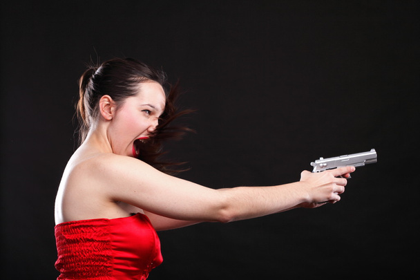 Sexy young woman - gun on black background - Fotó, kép