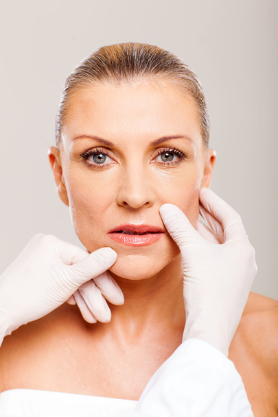 checking middle aged woman lips before plastic surgery - Foto, imagen