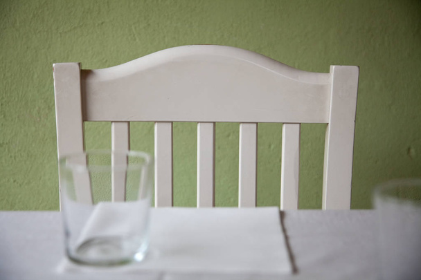 Sedia bianca vuota vicino al tavolo
 - Foto, immagini