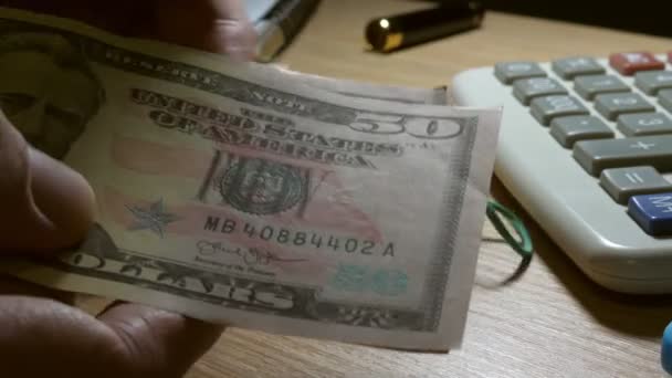 Man holding and counting dollar bills. Wealth and savings concept. - Materiał filmowy, wideo