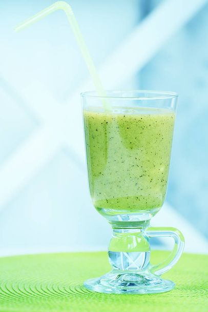 Kiwi drink in a glass goblet. Healthy lifestyle and proper nutrition. - Photo, Image