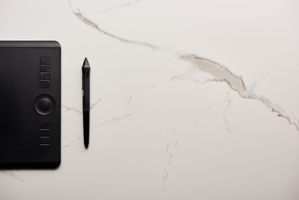 top view of graphics tablet on white marble surface - Photo, Image
