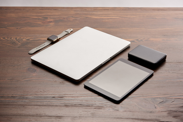 タブレット、スマートな時計木製のテーブルにポータブル hdd とノート パソコン - 写真・画像