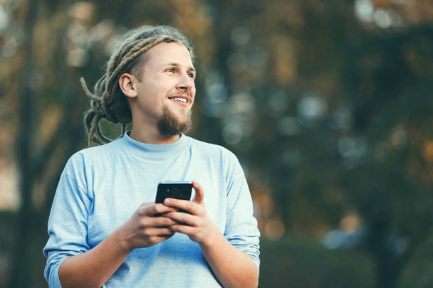 Blonde Bearded Man Walking On The Street And Chating On The Smartphone - Фото, изображение