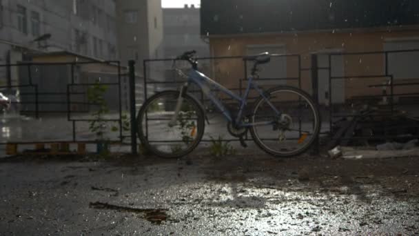 Bike parked near the fence in rainy weather - Footage, Video