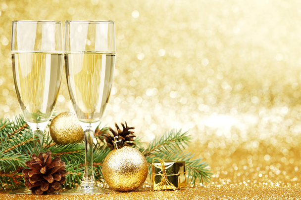 Champagne and new year decorations on golden background - Foto, imagen
