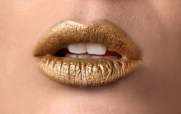 Beautiful woman with golden lips, closeup - Foto, Imagen