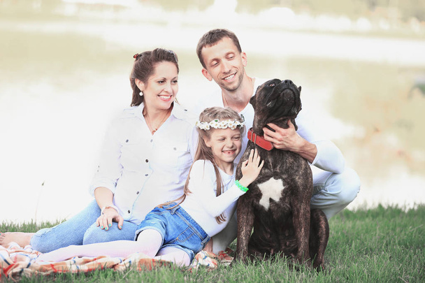 happy family with pet dog at picnic in a Sunny summer day. pregn - Valokuva, kuva